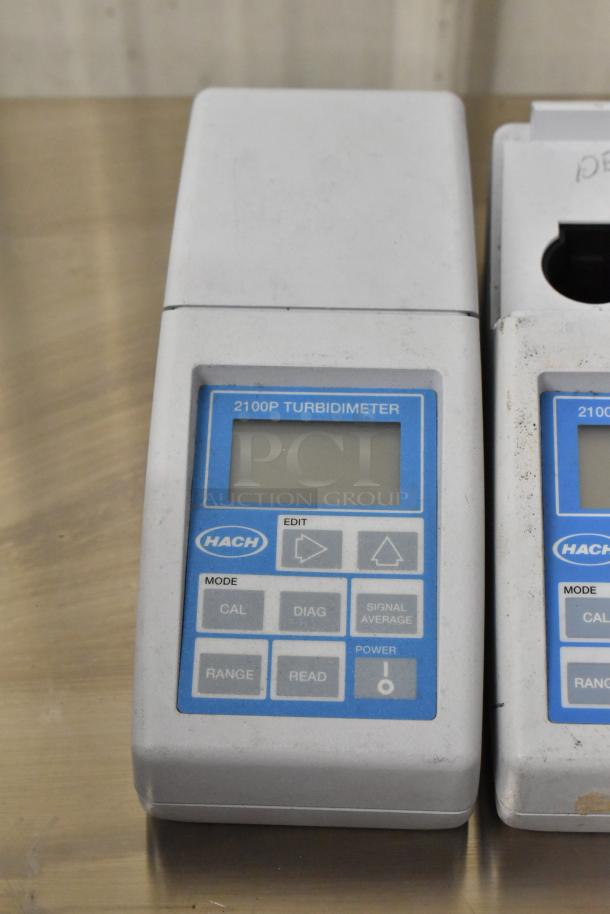 Hach 2100P Turbidimeter showing front display with brand and model label, buttons for mode and power. Used condition.