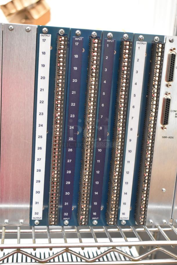 Analog & Digital Switchers A&D Unit with multiple input/output ports, metal casing, labeled connections, and visible circuitry.
