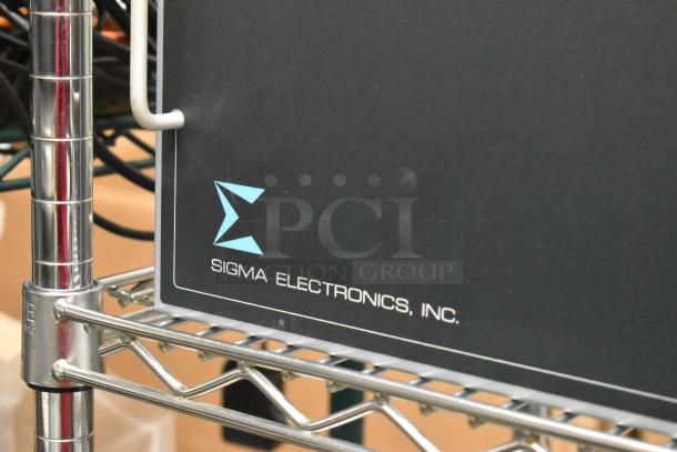 Analog & Digital Switchers A&D Unit by Sigma Electronics, Inc. on metal shelving. Black exterior, visible logo.