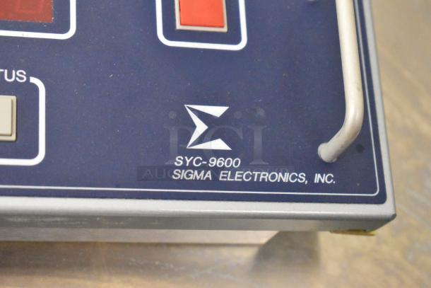Sigma Electronics SYC-9600 panel close-up, featuring control buttons and logo. Includes SBX-32 switchers.