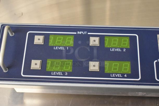 Sigma Electronics SYC-9600 unit showing input levels 1-4 on digital displays. Buttons for each level visible.