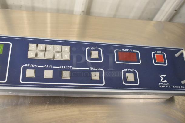 Sigma Electronics SYC-9600 control panel with button keypad, status indicators, and branding. Appears in used condition.