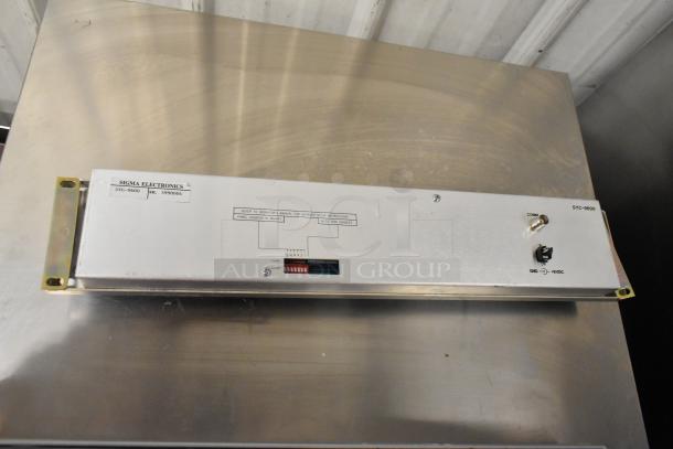 Sigma Electronics SYC-9600 unit with visible switches and connectors. Good condition, labeled with serial number 5990004.