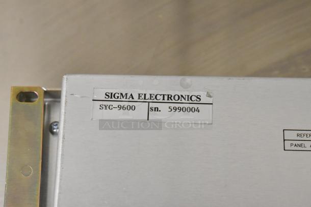 Sigma Electronics SYC-9600 with serial number 5990004, showing metal casing and label details.