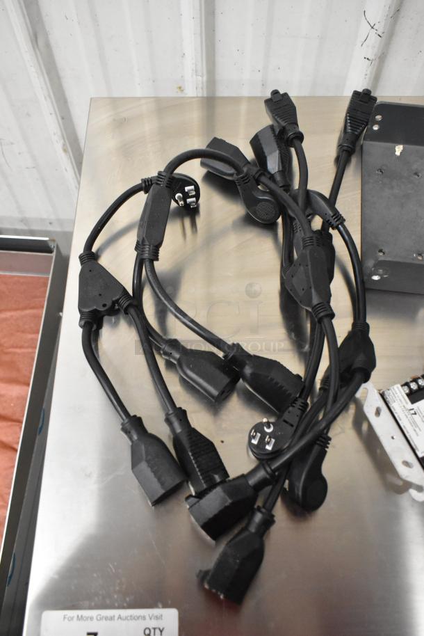 Lot including various black electrical wires and a Siemens TRI-R unit, displayed on a metallic surface.