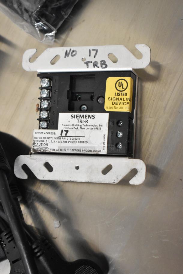 Lot of assorted items including wires and Siemens TRI-R unit with UL listed signaling device label and handwritten notes.
