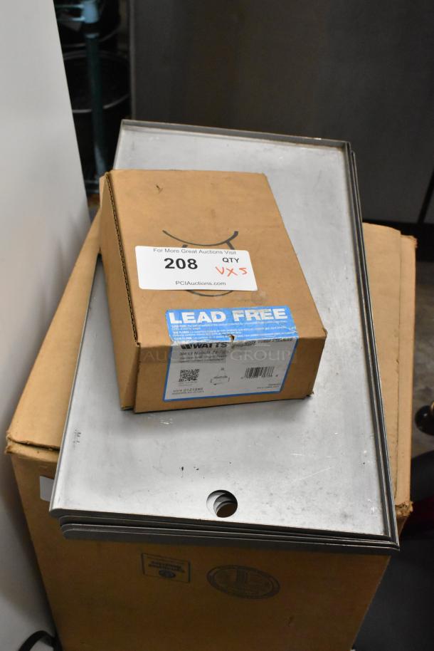 Cardboard box labeled "Watts LFN250B-Z2-D20 Regulator, Lead Free" atop stacked metal panels. Auction tag indicates five items.