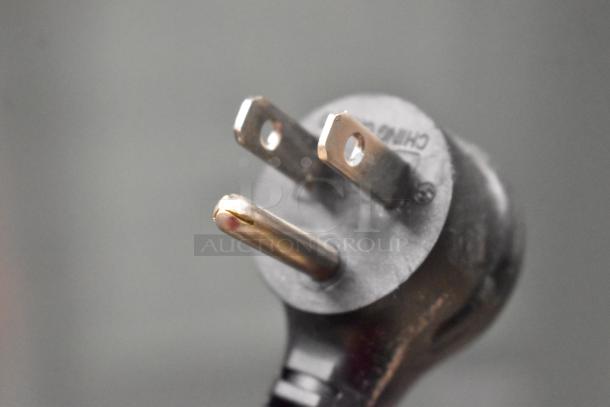 Close-up of a power plug end for the True TSCI-600R-G-PH cooler, showing a standard U.S. 115V connection.