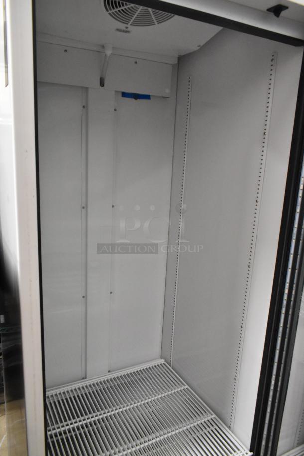 2021 True TSCI-600R-G-PH single door cooler, metal, poly coated racks, 115 volts, 1 phase, interior view.