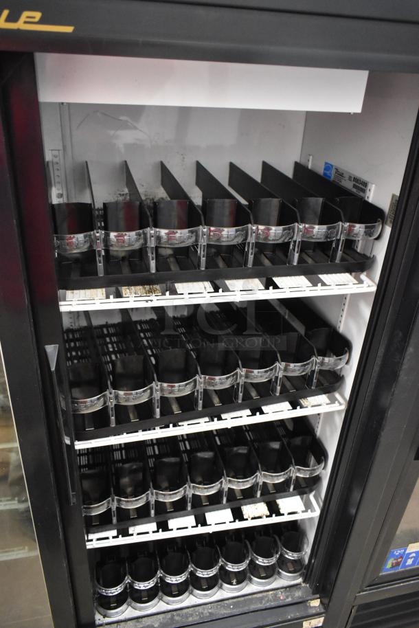 True GDM-41SL-60-LD commercial 2-door reach-in cooler with poly-coated racks, model label visible inside.