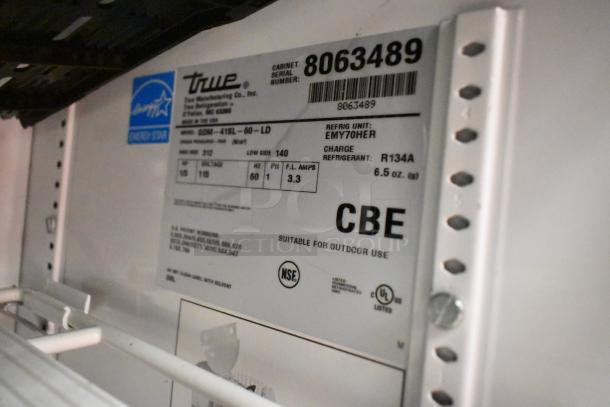 True GDM-41SL-60-LD cooler label with model info, serial number 8063489, 115 volts, 1 phase, R134A refrigerant.