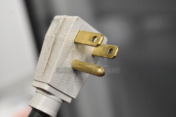 Close-up of a power plug for the True GDM-41SL-54-LD commercial cooler, showcasing its electrical compatibility.