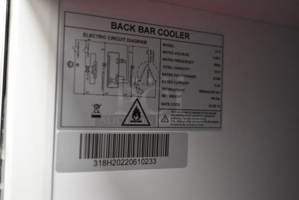 Metal commercial single door reach-in cooler with poly-coated racks. Features 115 volts, 1 phase. Tag lists model A-11, 10 ft³ capacity. Refrigerant: R600a.