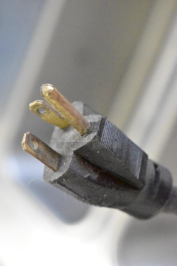 Close-up of a three-prong power plug for a Stoelting soft serve ice cream machine, 208-240 volts, 1 phase.