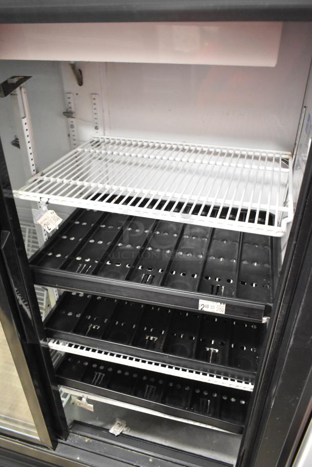 True GDM-41SL-60-LD 2-door cooler merchandiser with poly-coated racks, 115 volts, 1 phase, tags visible, clean condition.