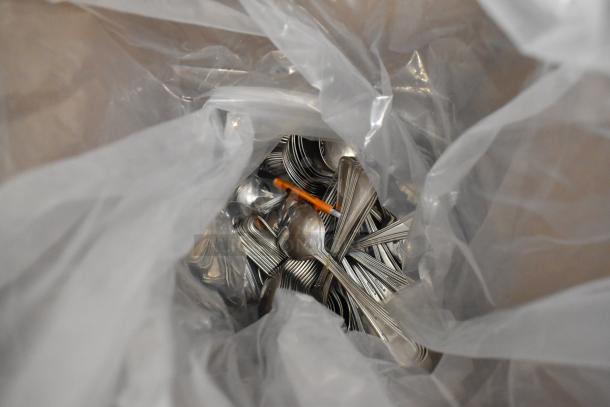 Bag of new stainless steel spoons, unboxed. Scratch and dent condition, bundled for auction sale.