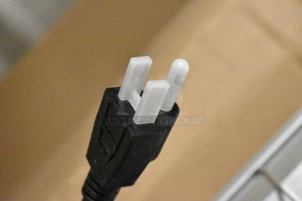 Close-up of a three-prong plug for the Avantco 413GRAH42TAS 42" infrared food warmer, indicating electrical compatibility.