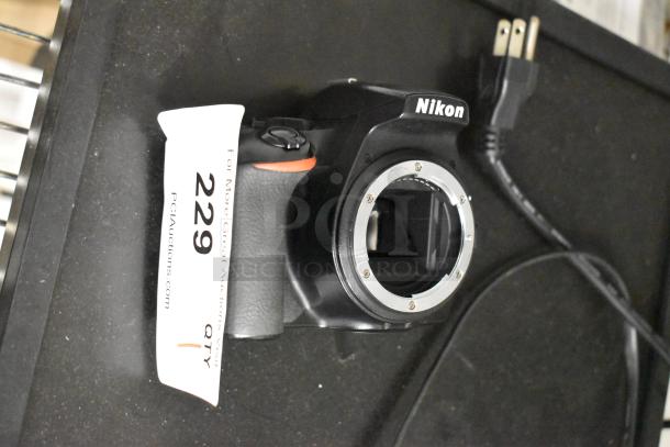 Nikon D3500 digital camera body only, no lens, excellent condition, auction tag "229" visible.