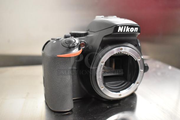 Nikon D3500 digital camera body, no lens, black finish, showing front and grip, in good condition.