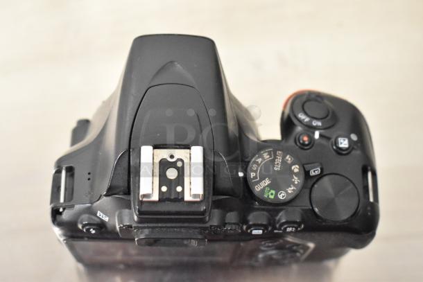 Nikon D3500 digital camera body, no lens. Features mode dial and hot shoe. Black finish in good condition.