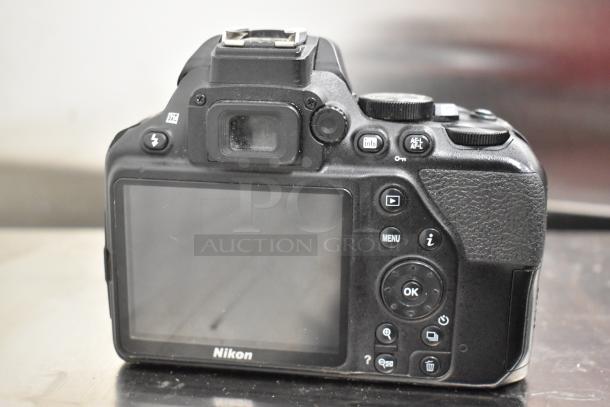 Nikon D3500 digital camera body, no lens, rear view showing screen and control buttons, in used condition.