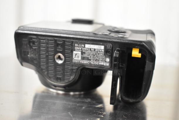 Nikon D3500 camera body, bottom view. Good condition, label indicates made in Thailand. No lens included.