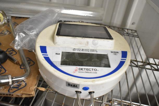Detecto produce scale SCS30 on a metal shelf, showing digital display. Includes poly bins and whisks in the background.