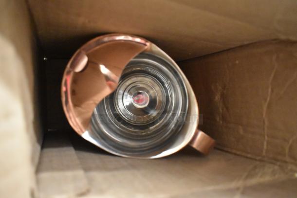 Box containing a reflective metal object inside a cardboard box. Part of a mixed lot including ice melt, utensils, and metal panel.