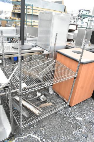 Chrome finish 2-tier wire shelving unit, assembled, with visible wear. Buyer must dismantle. Consider freight charges.