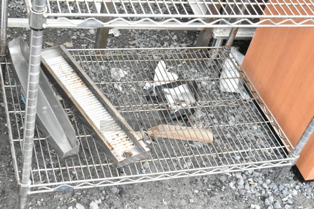 Chrome finish 2-tier wire shelving unit with visible rust, buyer must dismantle, suitable for storage, check freight costs.