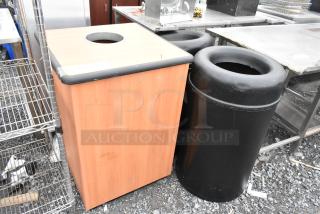 3 trash can shells; 2 black cylindrical, 1 wood-patterned square. Used condition, outdoor setting.