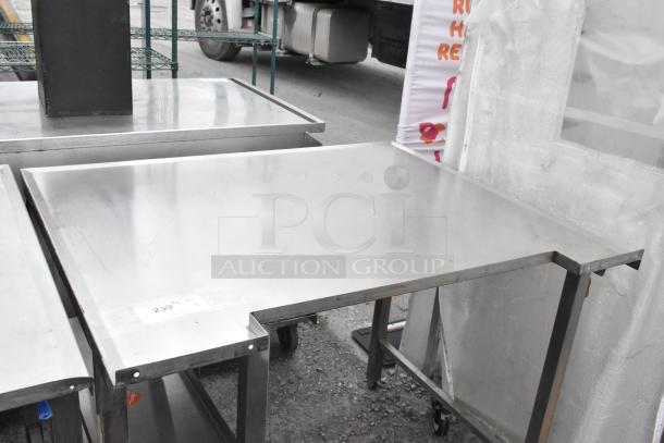 Stainless steel table with a flat, smooth surface. Appears in used condition. Label indicates lot number 239.