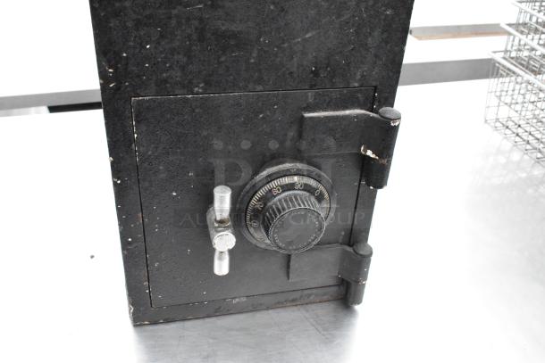 Black drop safe with combination dial and metal handle; moderate wear; combination not included.