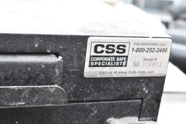Corporate Safe Specialists black metal single compartment safe. Visible wear, no combination included. Serial #SG 000821.