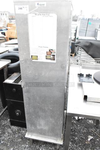 Lockwood CA60-RR25 metal commercial enclosed pan rack with visible baking pans, slight wear, and Bread In Time Log label.