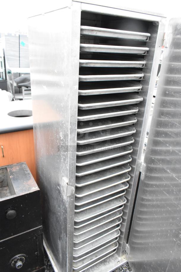 Lockwood CA60-RR25 metal commercial enclosed pan rack with multiple metal baking pans, used condition.