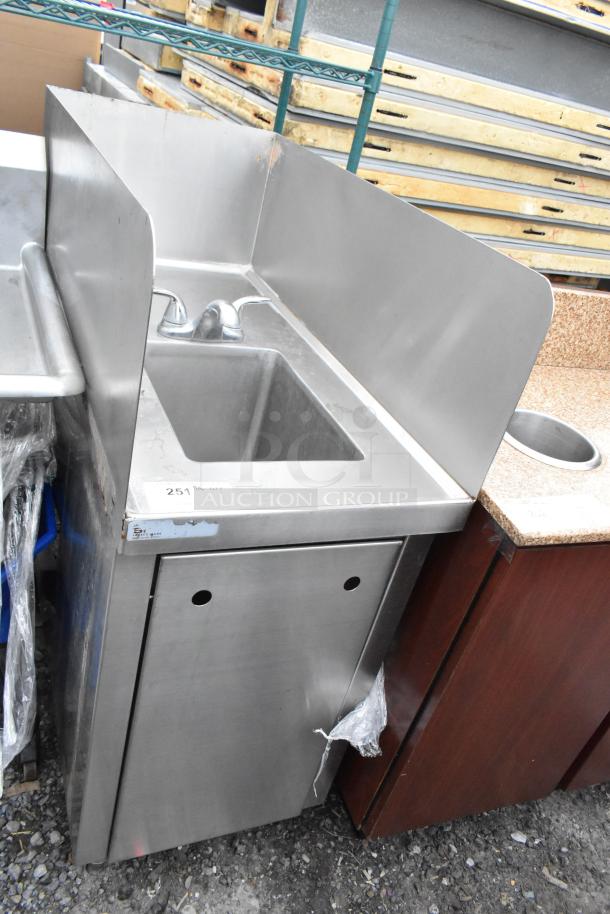 Stainless steel single bay sink with faucet, dual handles, and splash guards. Tag reads "251". Used condition.