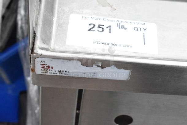 Stainless steel single bay sink with faucet, handles, and splash guards. Includes label "SPI Expect More, Aurora, CO, USA." Signs of wear.