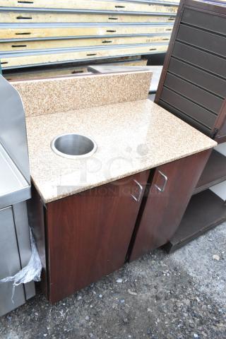 Granite-top trash can shell with metal deposit hole and two wood-finished doors. Item label reads "252".