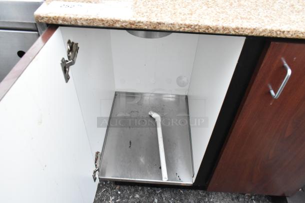 Trash can shell with granite top, featuring trash deposit hole and two doors. Interior shows signs of use.