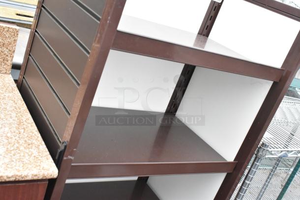 Dark wood pattern shelving unit with three spacious shelves, in good condition. Ideal for storage or display.