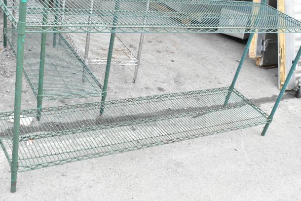Green finish 4-tier wire shelving unit, open design, used condition. Buyer must dismantle and arrange freight shipping.
