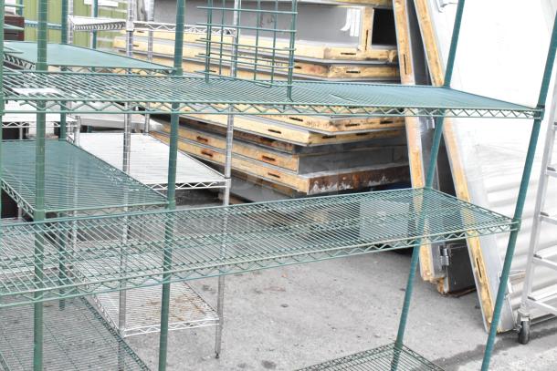 Green 4 tier wire shelving unit in used condition, features sturdy metal construction. Buyer must dismantle for shipping.