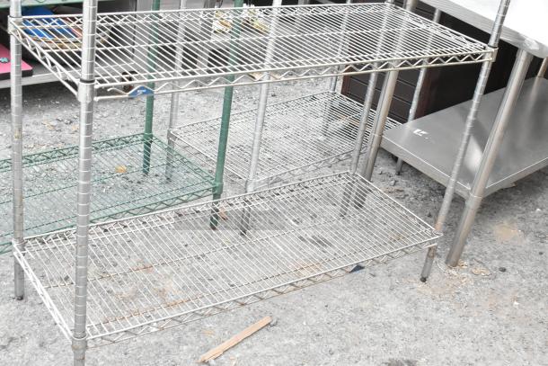 Chrome finish 3-tier wire shelving unit, dismantling required, sturdy condition, ideal for storage.