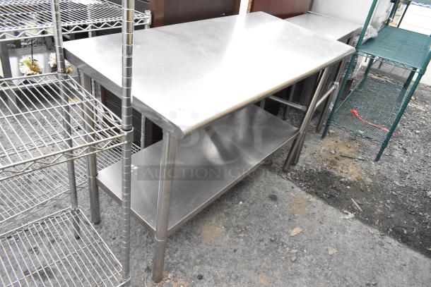 Stainless steel table with under shelf, used condition, sturdy construction. Ideal for kitchens or workshops.