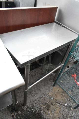 Stainless steel table with metal legs, rectangular design, slight wear. Features a price tag reading "259". Ideal for kitchen use.