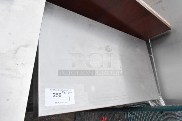 Stainless steel table with brushed finish, mild wear on surface, tag reads "259" and "QTY 1," PCI Auctions branding.