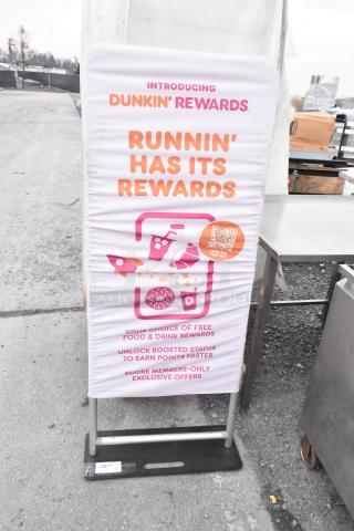 Dunkin Donuts rewards sign with promotions, pink and orange text, outdoor setting, mounted on a metal frame.