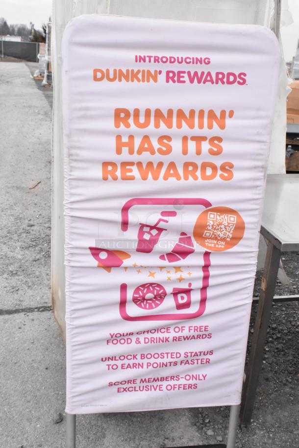 Dunkin Donuts sign promoting Dunkin' Rewards. Features phrases "Runnin' Has Its Rewards" and QR code. Good condition.