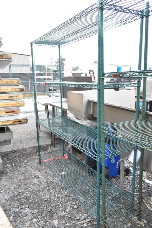 Green 4-tier wire shelving unit outdoors. Good condition. Buyer must dismantle. Consider freight charges.